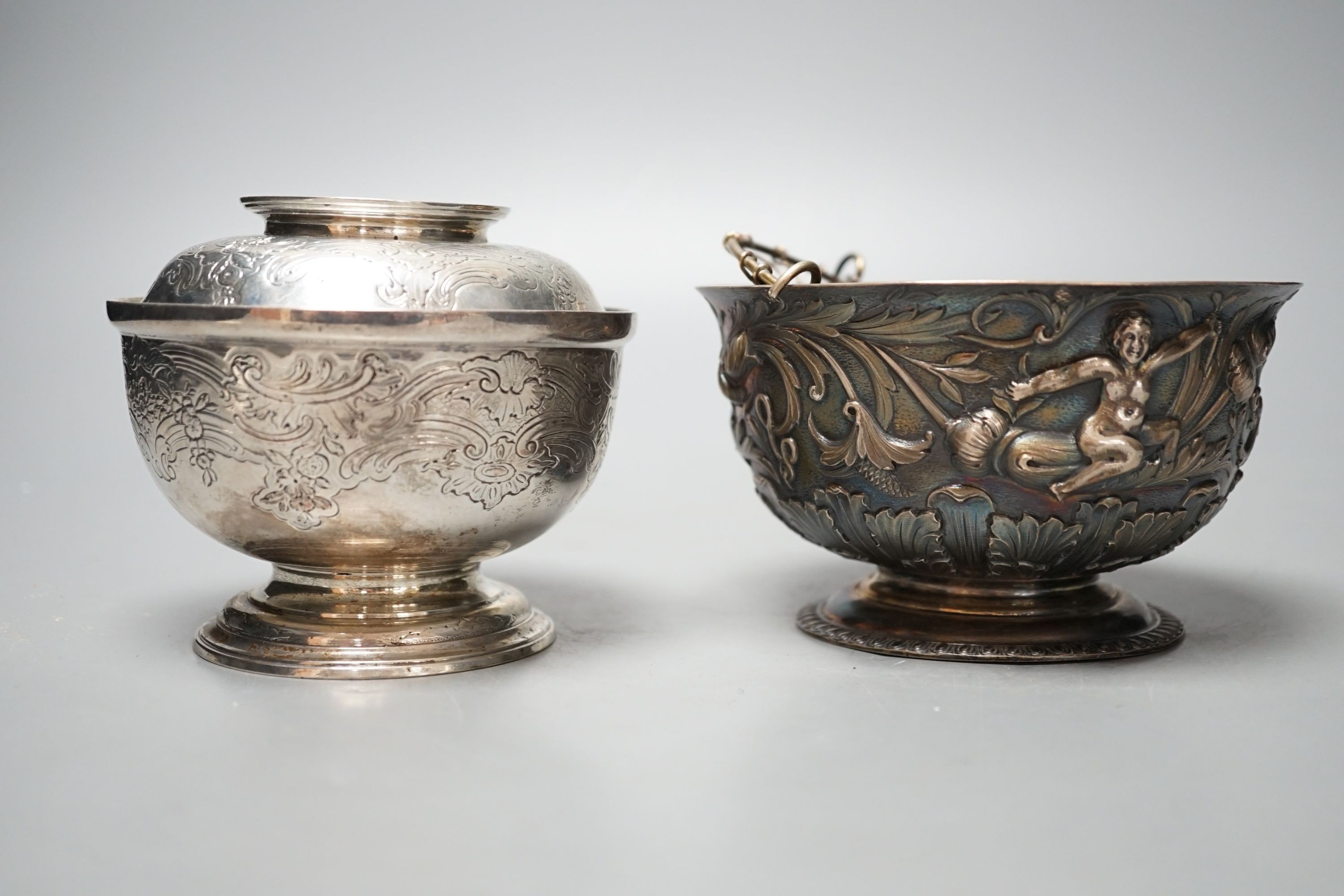 An Edwardian silver bowl, embossed with putto amid scrolls, London, 1902, diameter 13.1cm and a white metal bowl and cover, gross 20.5oz.